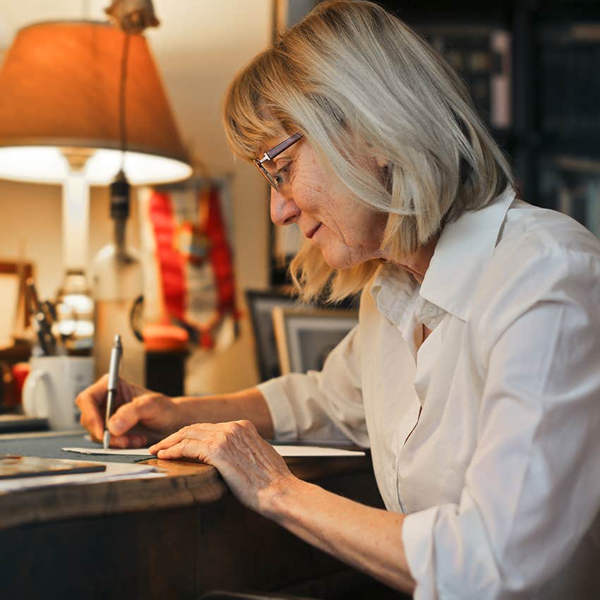woman who never seems to rush writing a letter