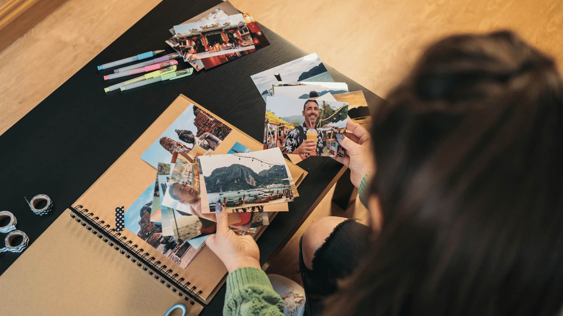 woman in black ripped skinny jeans scrapbooking
