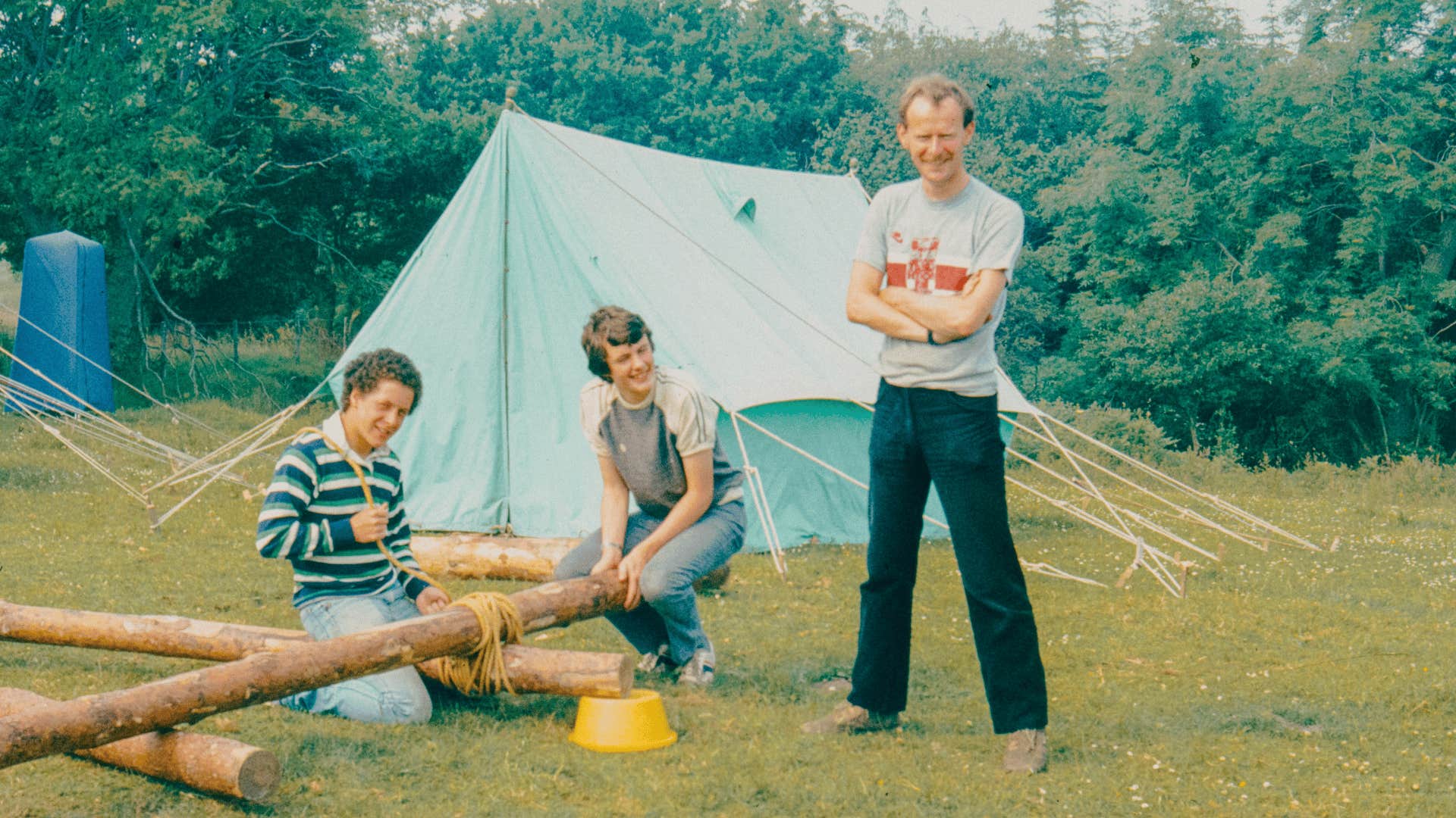 teens in the 1960s pitching a tent for camping
