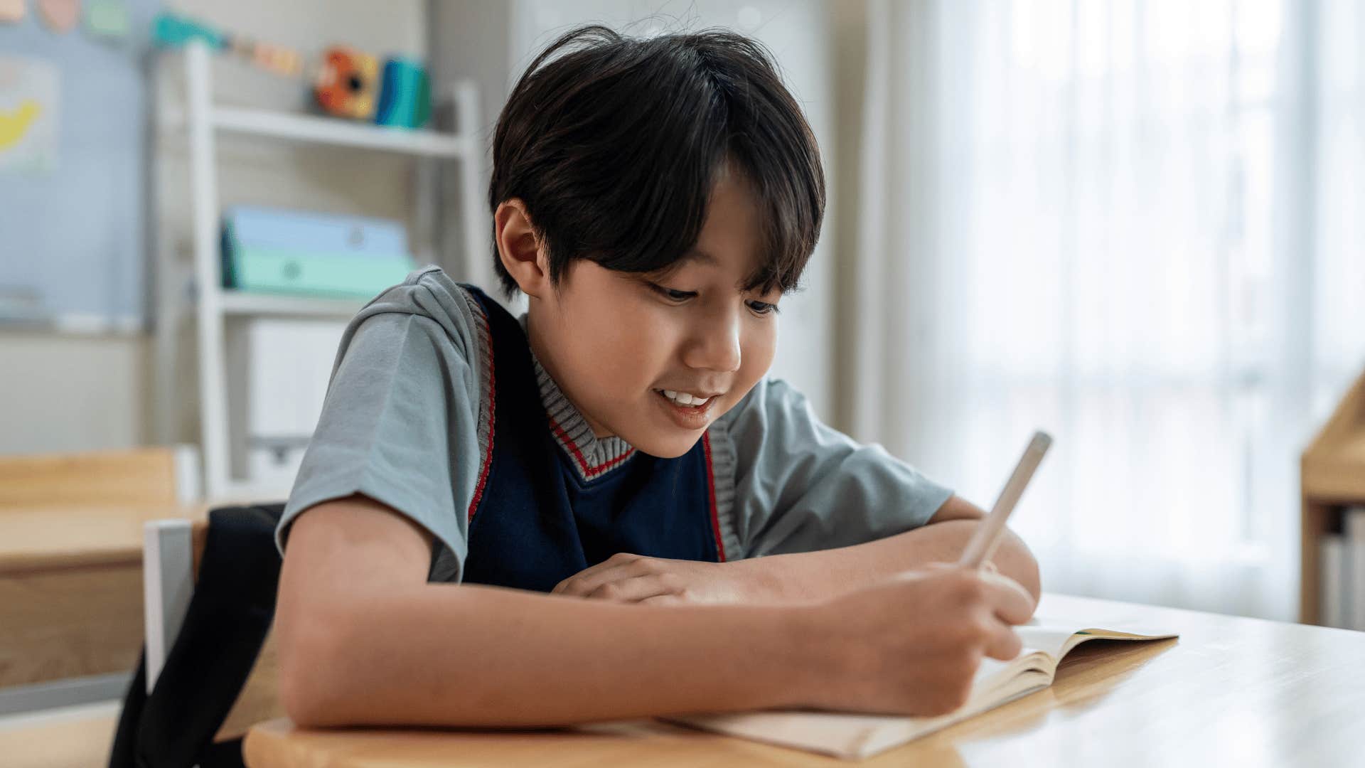 young boy writing a letter to his pen pal
