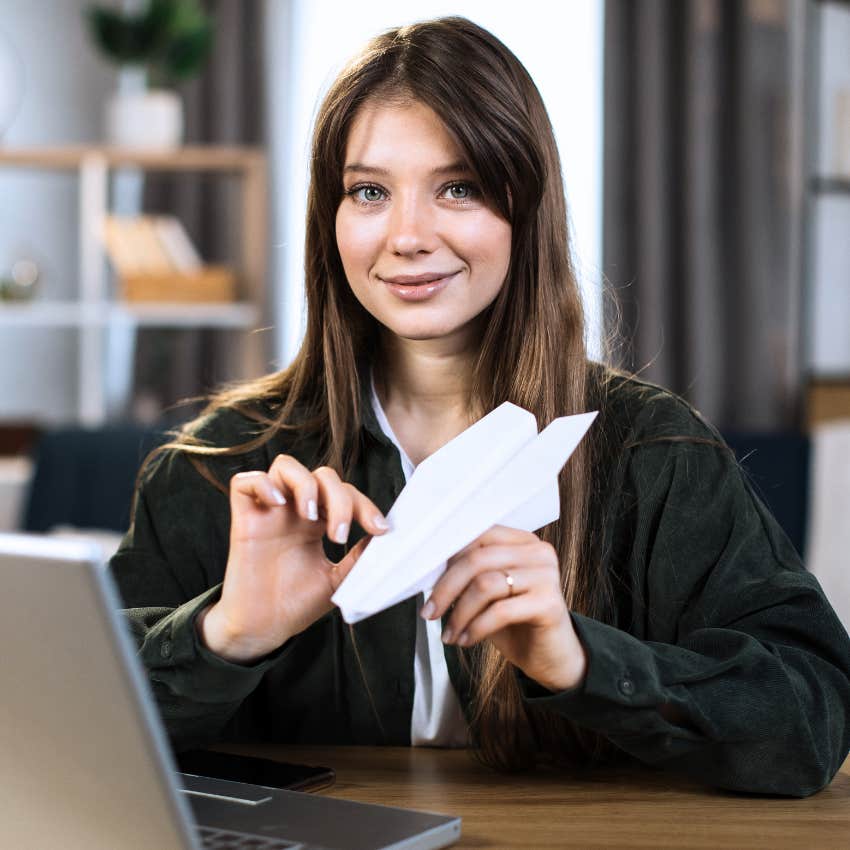 Gen Z woman doing origami at her desk