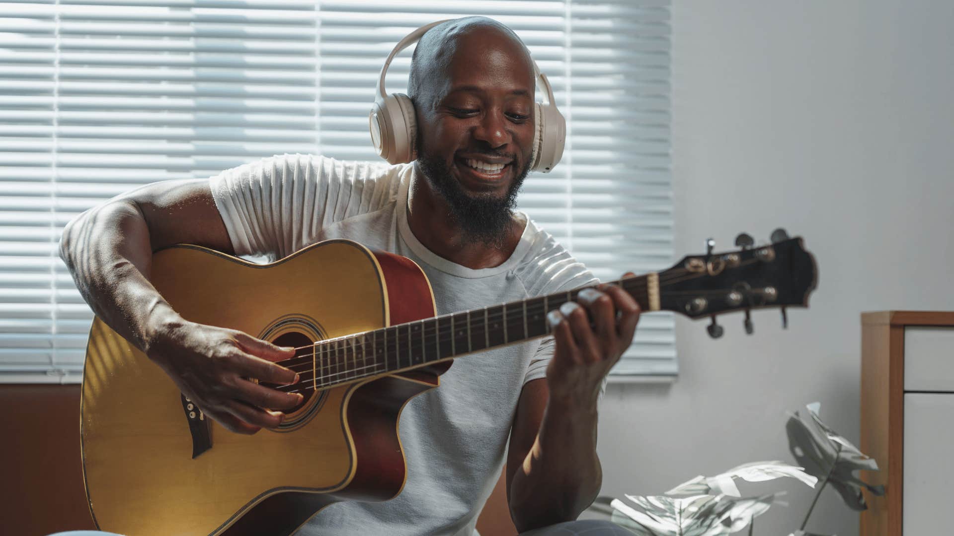 man playing guitar to join a band