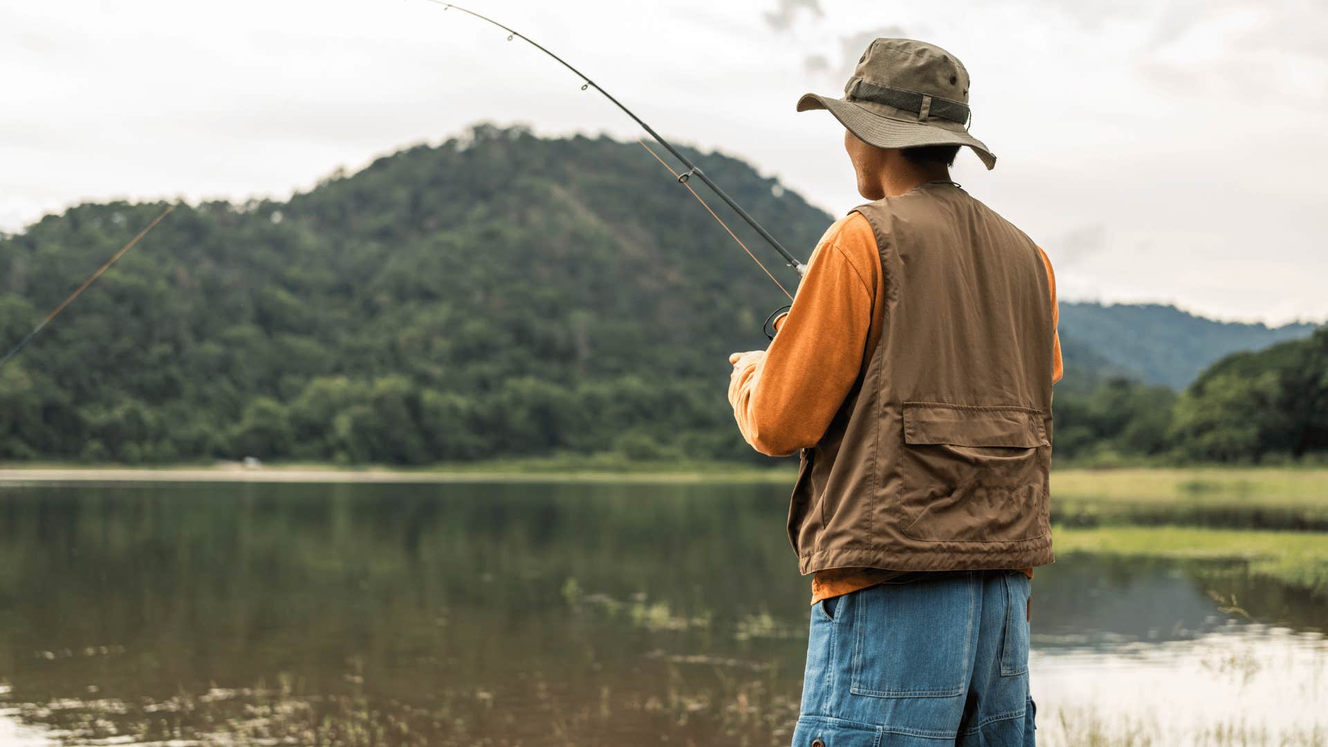 older man fishing in a lake