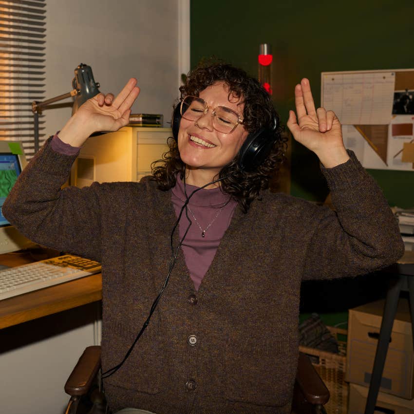 young woman listening to cassette tapes on a Walkman