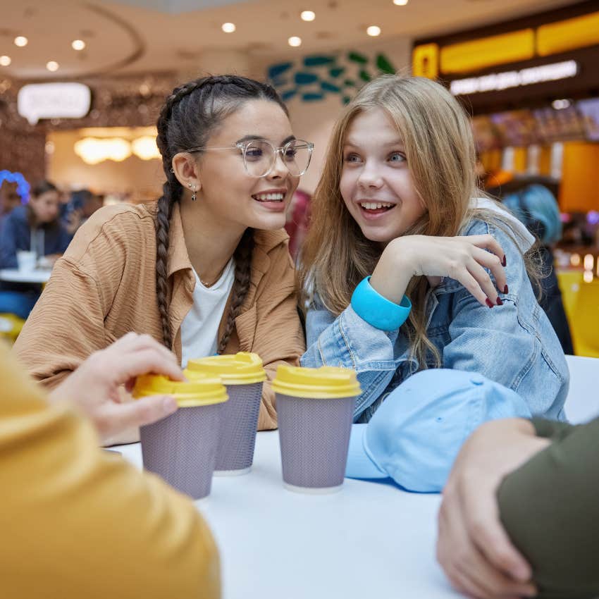 Gen Z girls smiling and going to the mall with friends