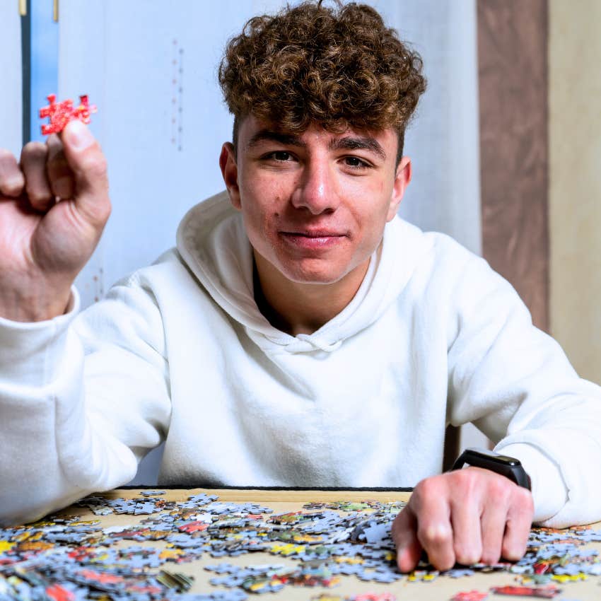 Young boy doing puzzles at home
