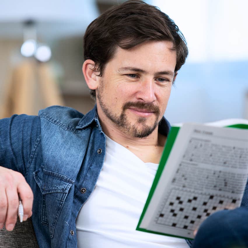 Man doing word puzzles at home