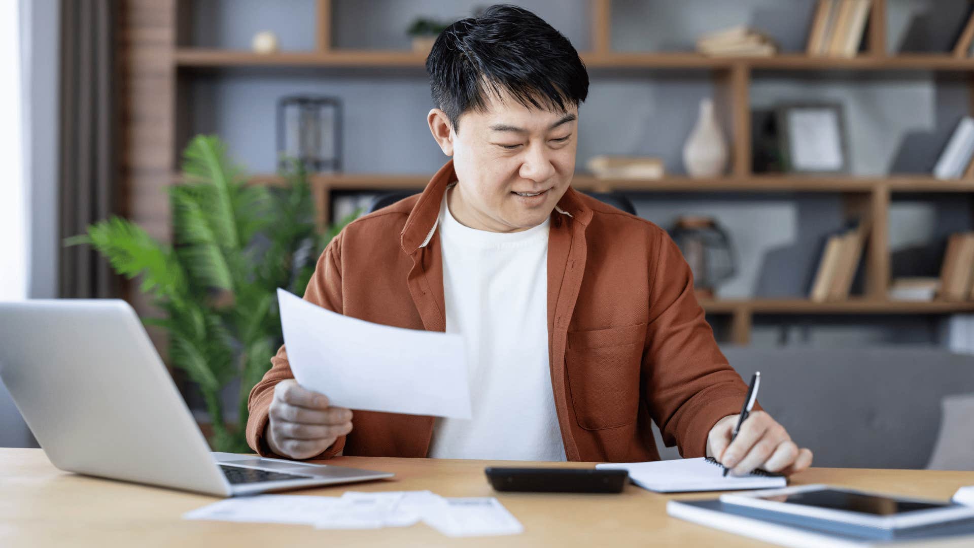 financially responsible man doing his bills at home
