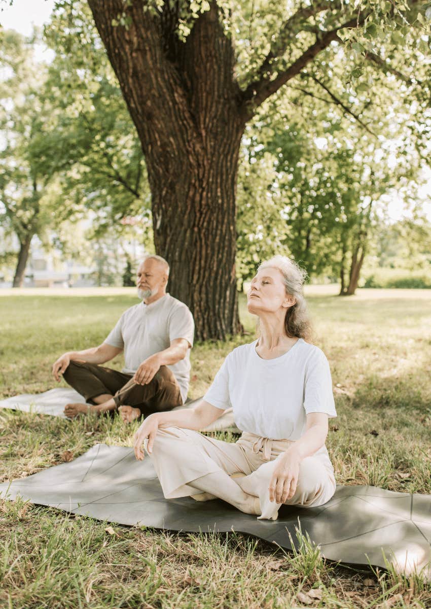 older couple doing yoga together with good posture