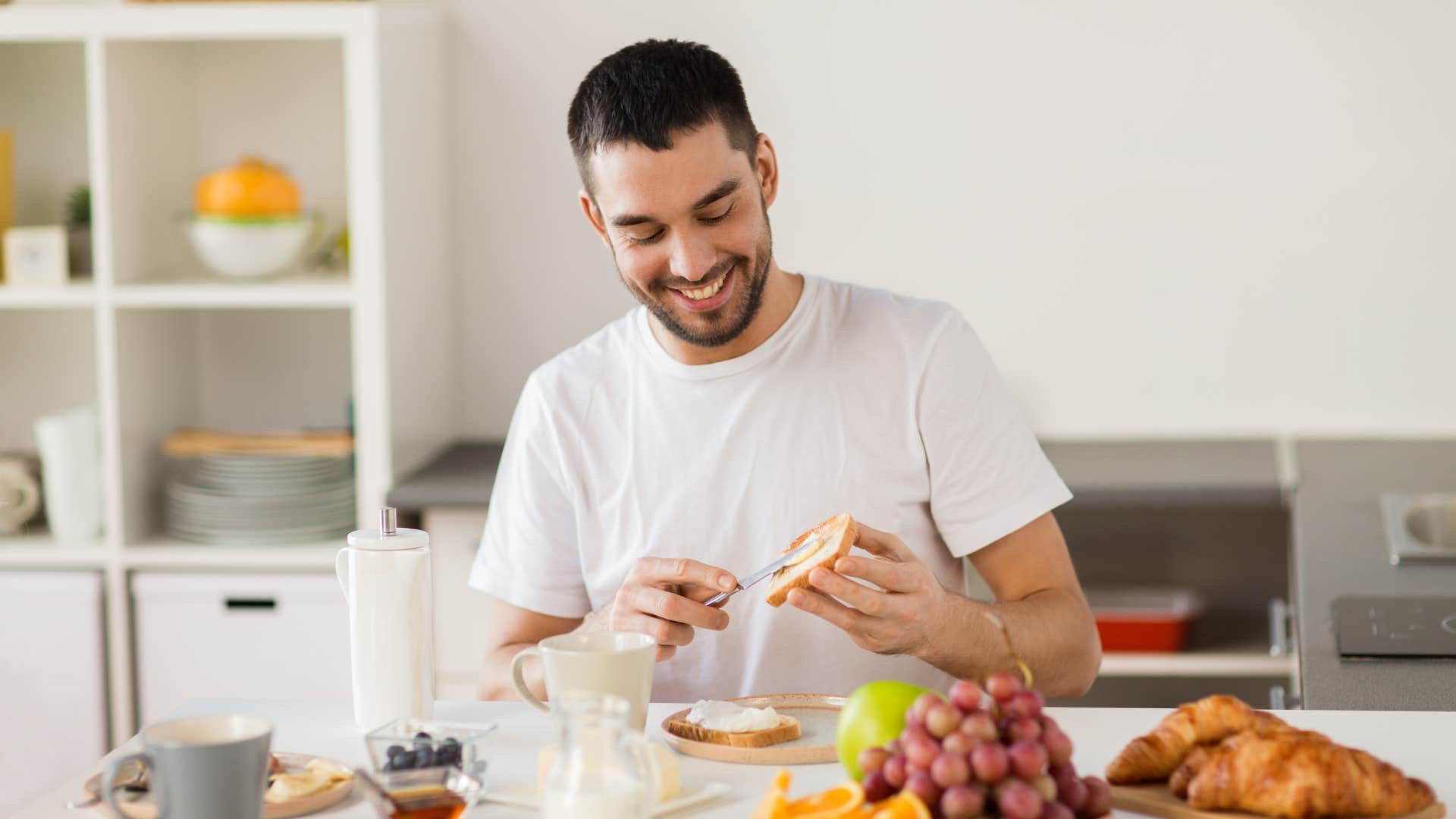 millennial man making avocado toast with butter