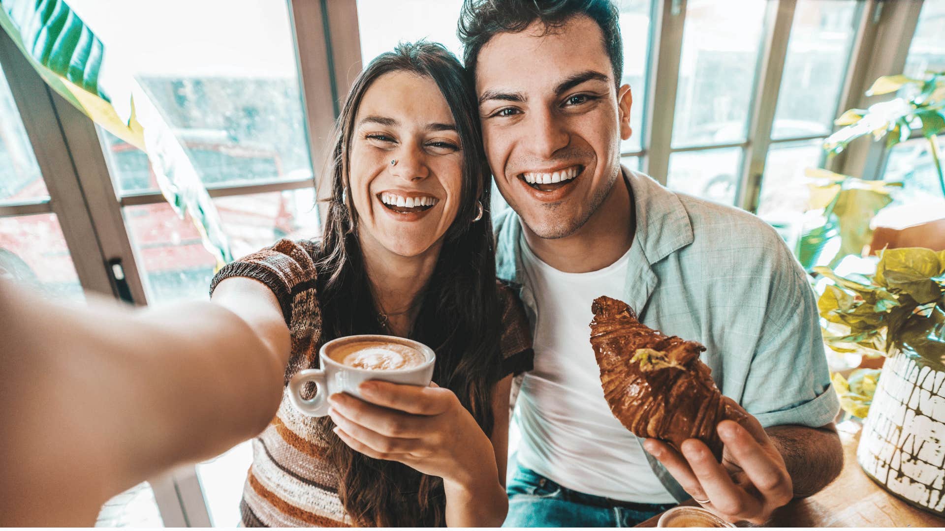 millennial couple treating themselves to cafe food and coffee
