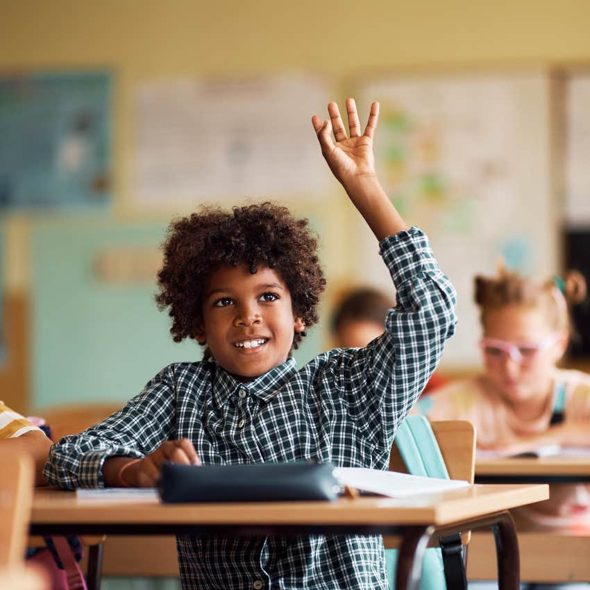 student raising his hands who has parents that don't protect him from hard things