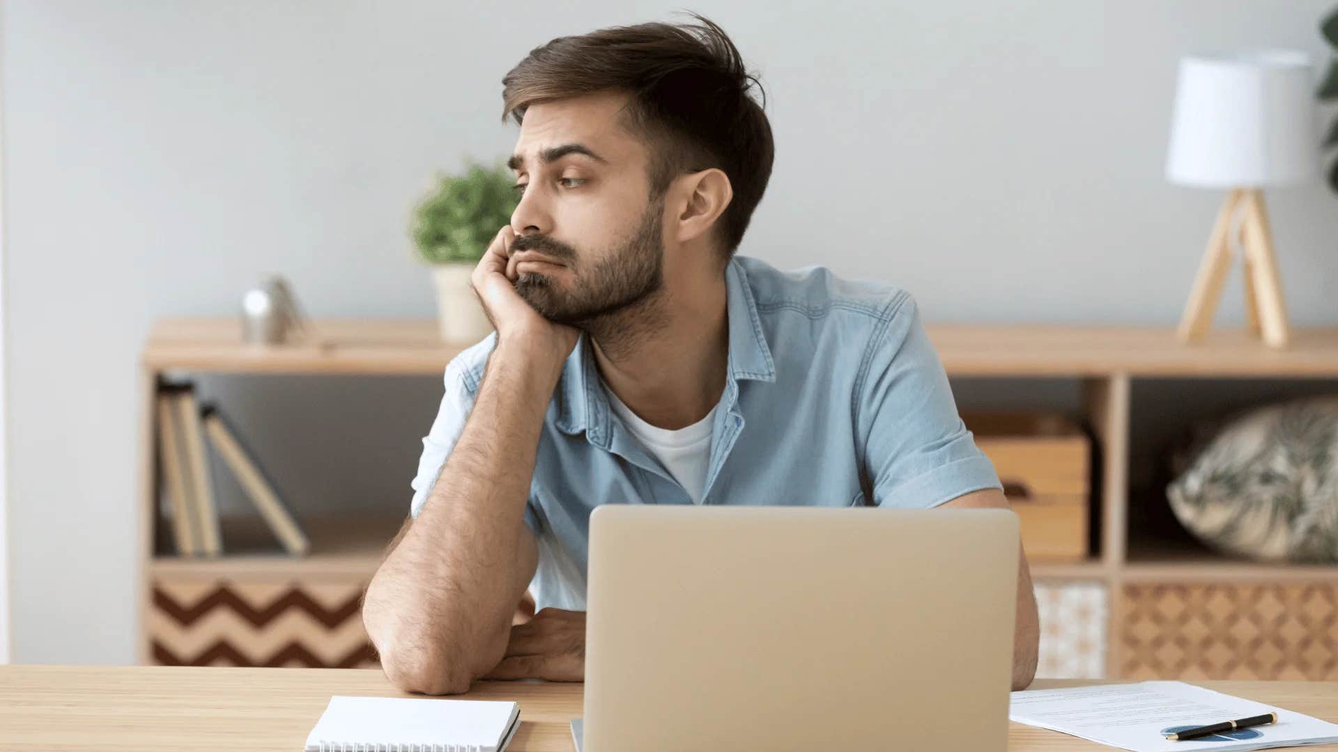 man with tense passive-aggressive body language because he secretly hates job
