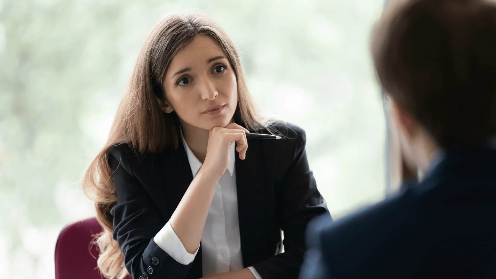 woman passive-aggressively deflecting personal questions because she secretly hates her job