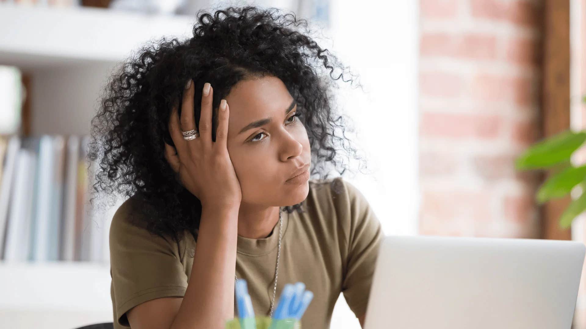 woman passive-aggressively won't decorate her workspace because she secretly hates her job