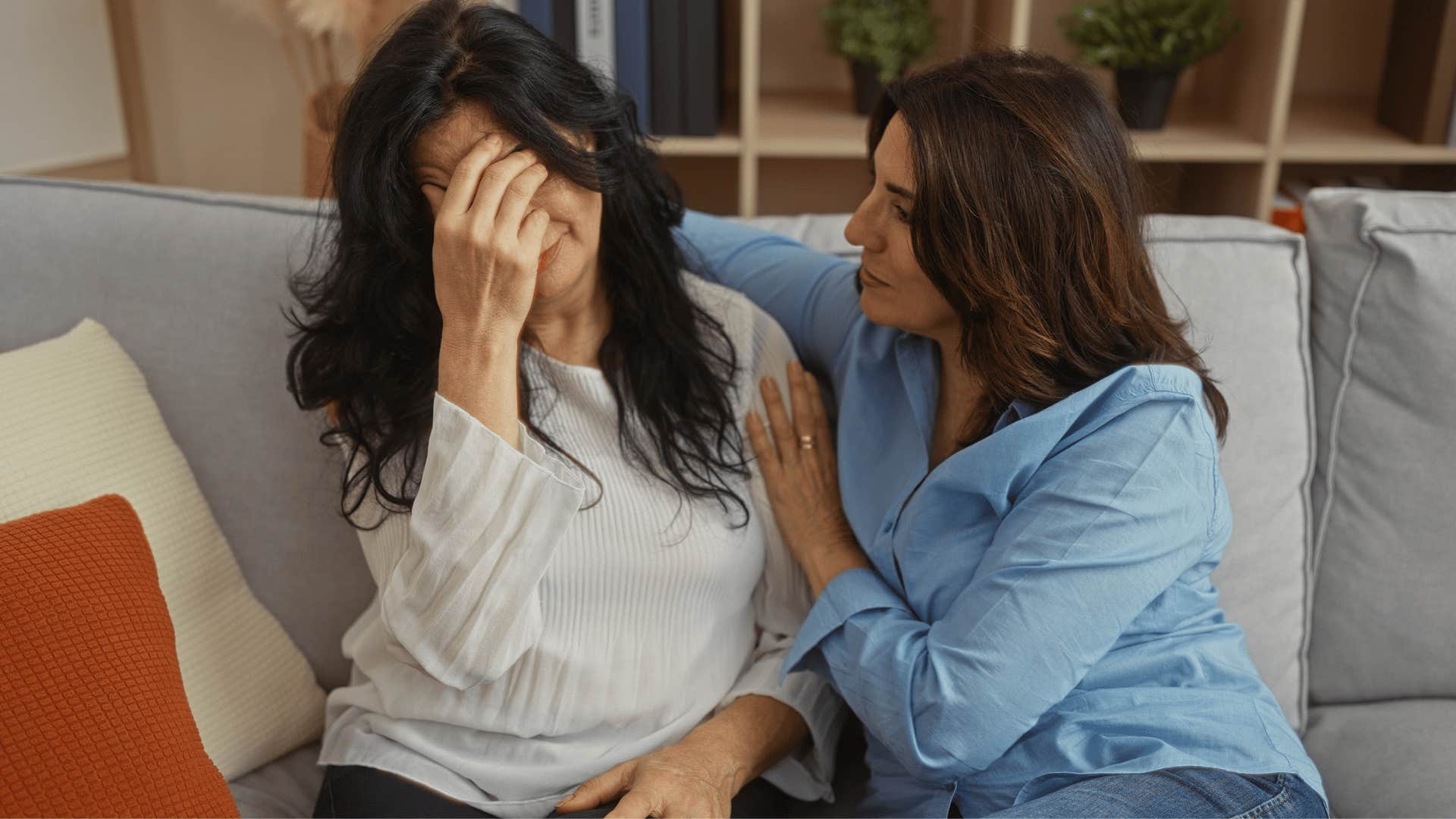 woman comforting friend who is playing the victim