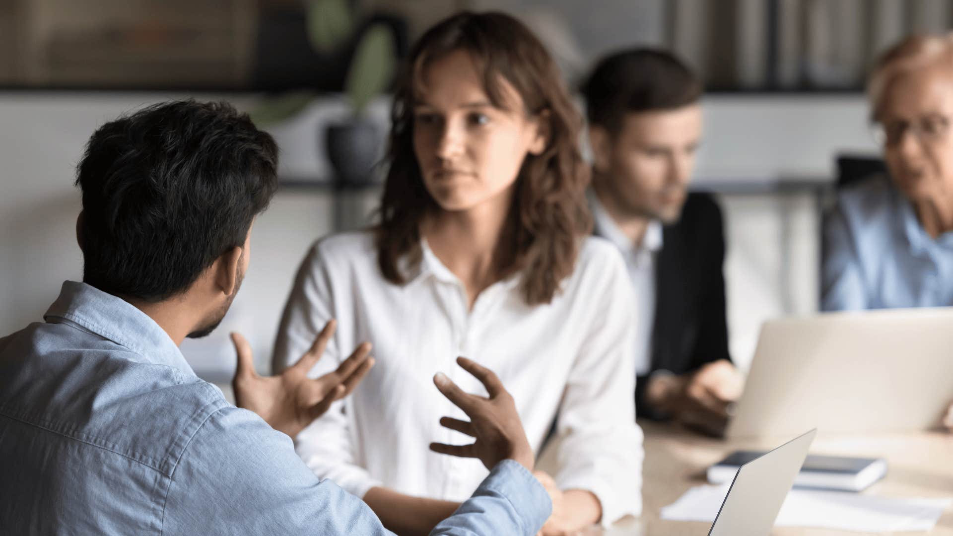 classy intelligent woman in white shirt telling man it depends on the context
