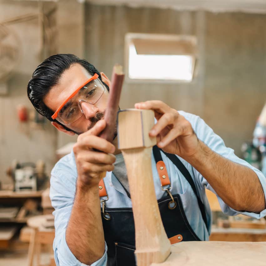 man doing woodworking project in crafting studio