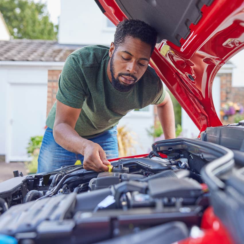 man working on his car's engine as a hobby
