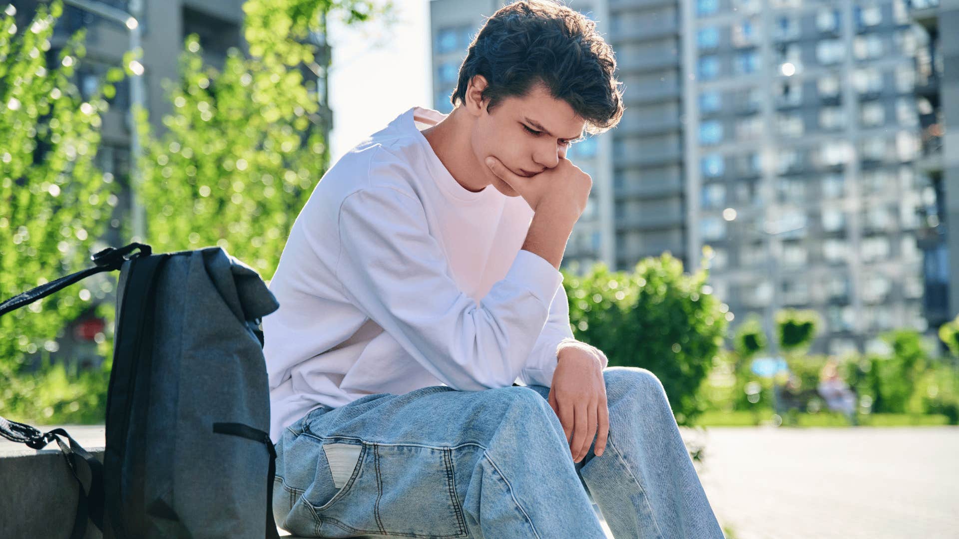 man in pink shirt upset outside as he thinks i don't belong anywhere