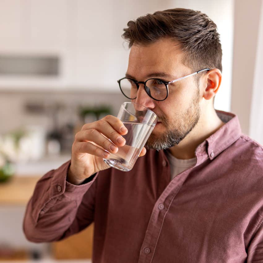 man combating the afternoon slump by drinking water