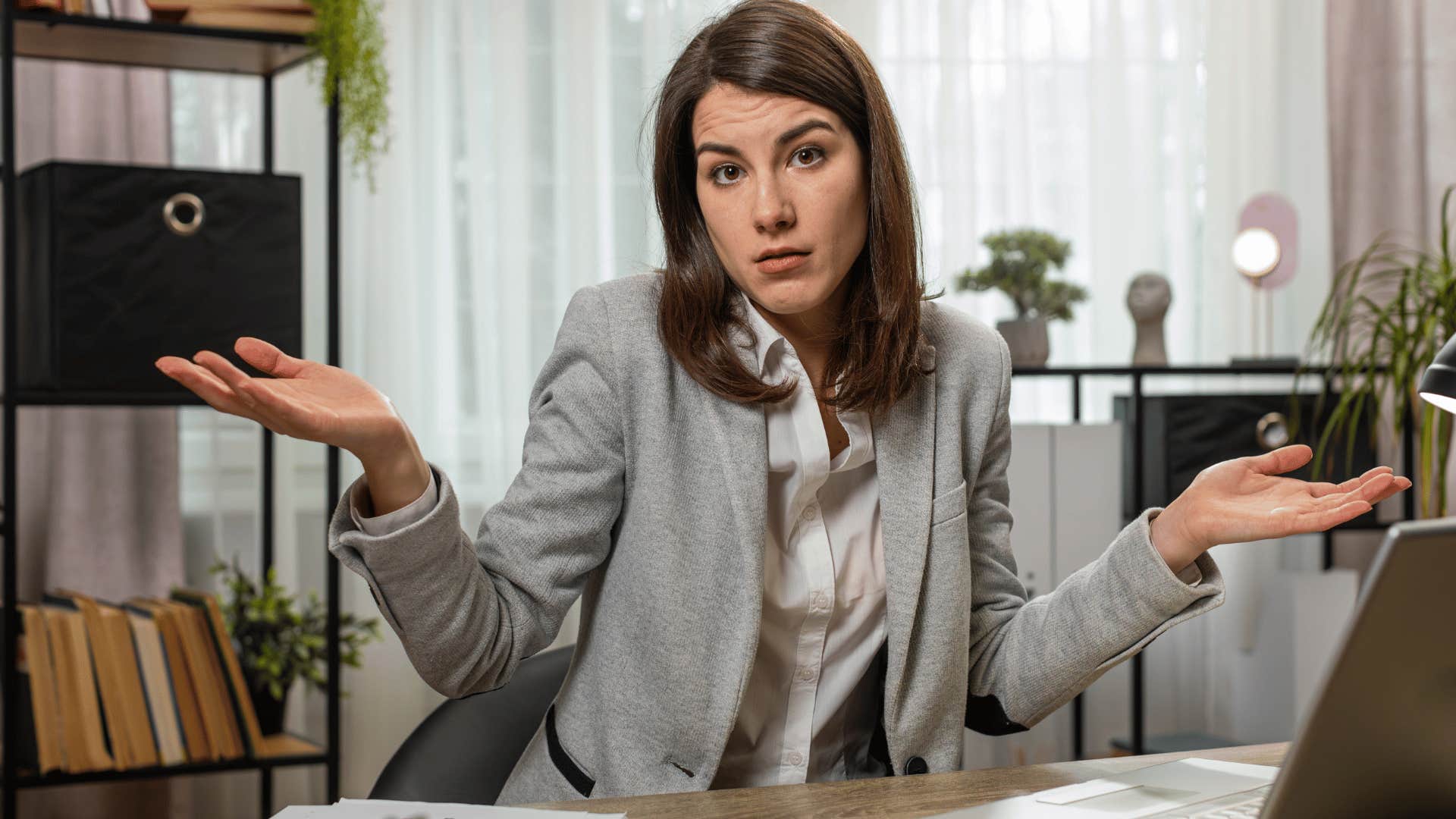 woman shrugging saying i don't owe them an explanation at work