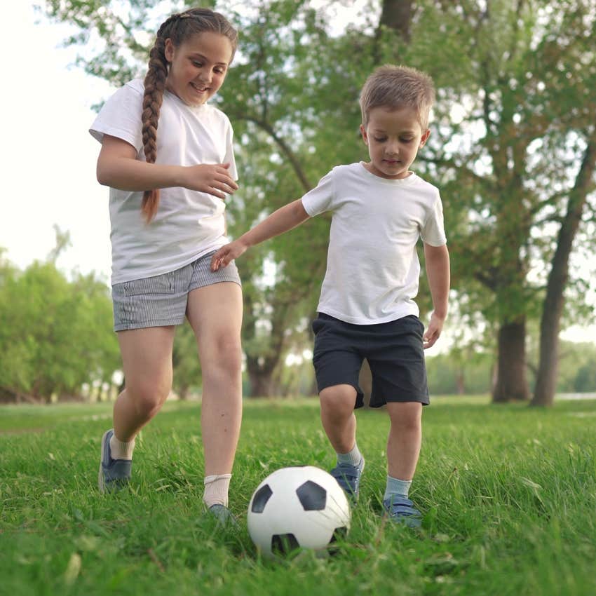 kids spending time outside playing soccer together