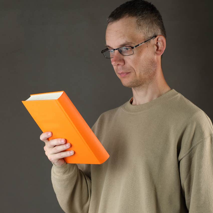 Man judging a book by looking at its cover