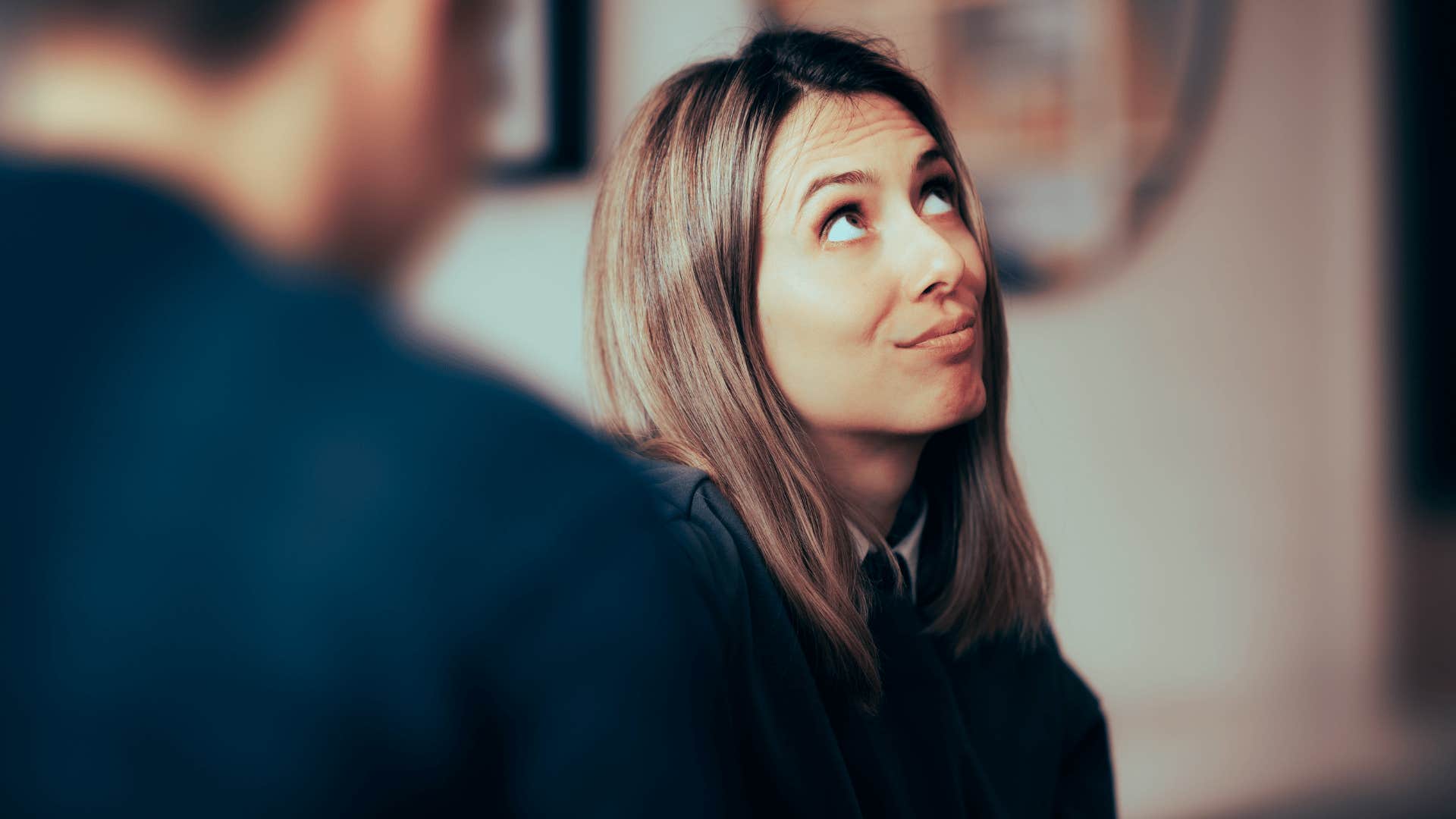 woman rolling eyes at man as she says whatever i don't care