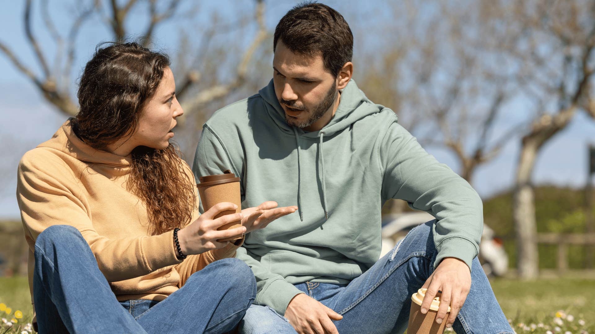 couple arguing as woman in yellow hoodie tells man you're too sensitive