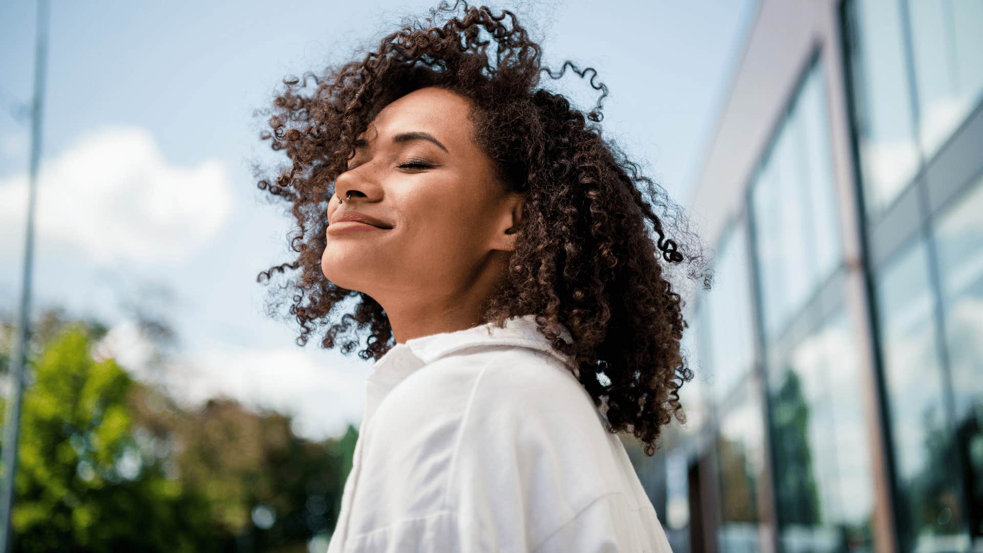 woman being selective about her energy standing outside happy