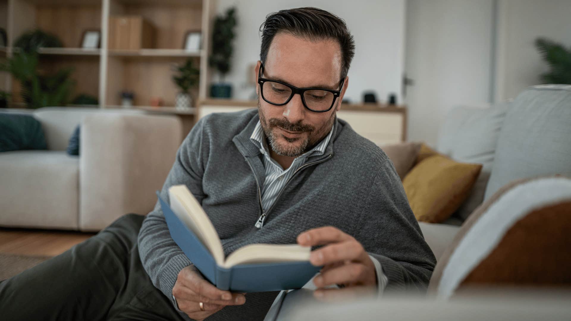 man guarding his peace by reading book at home