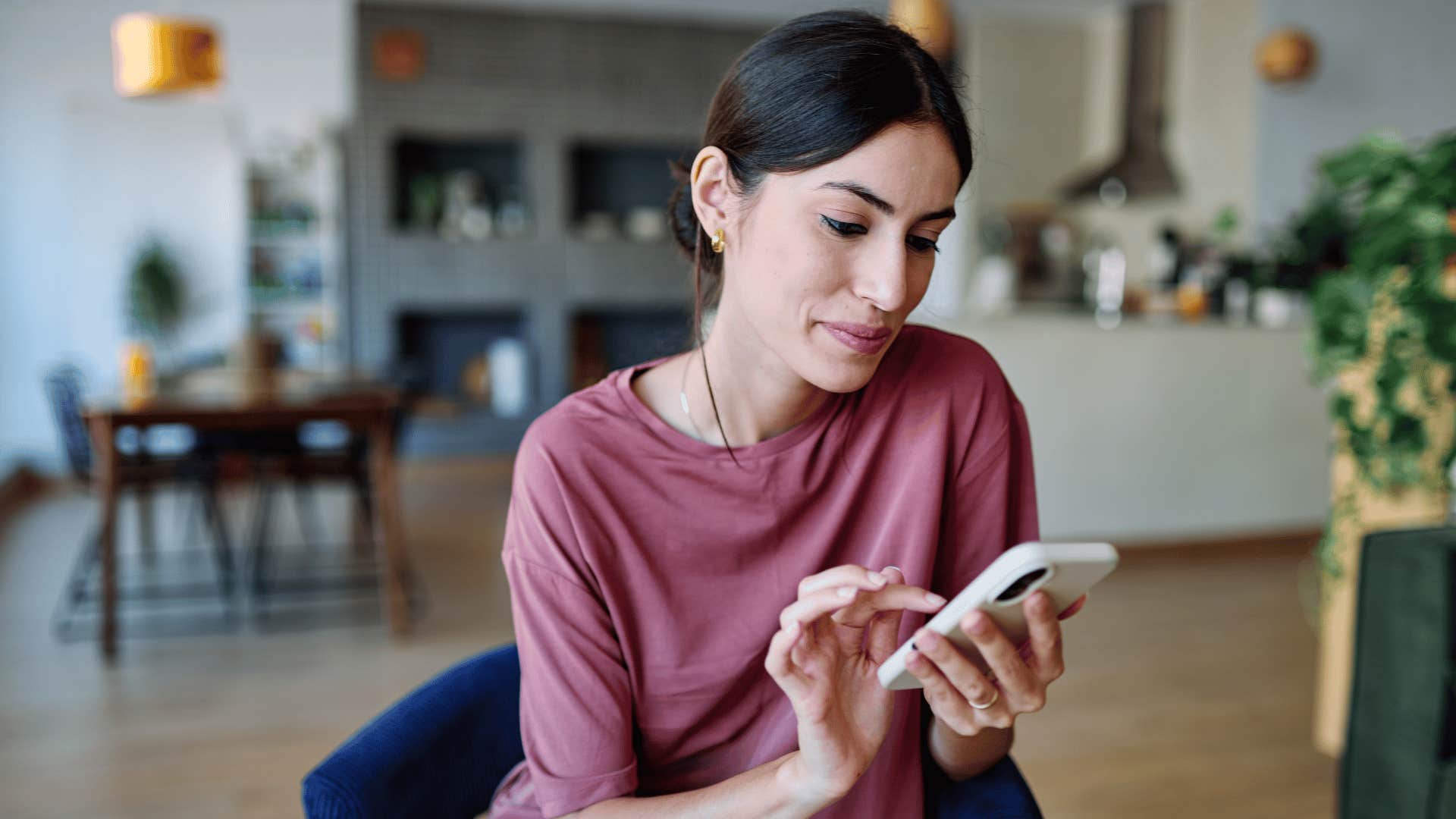 woman checking her phone observing other people's posts