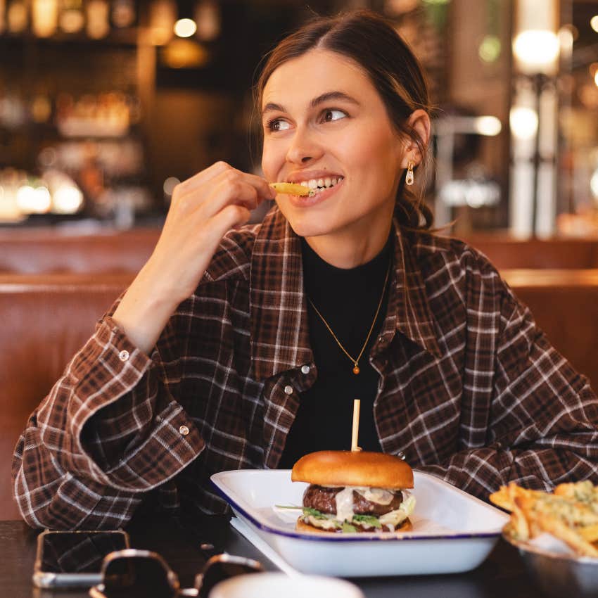 woman eating food at restaurant