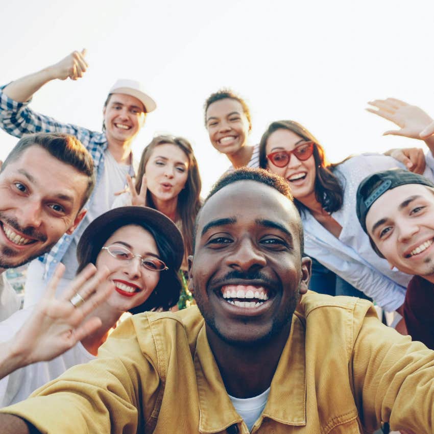 man surrounding himself with positivity and happy friends