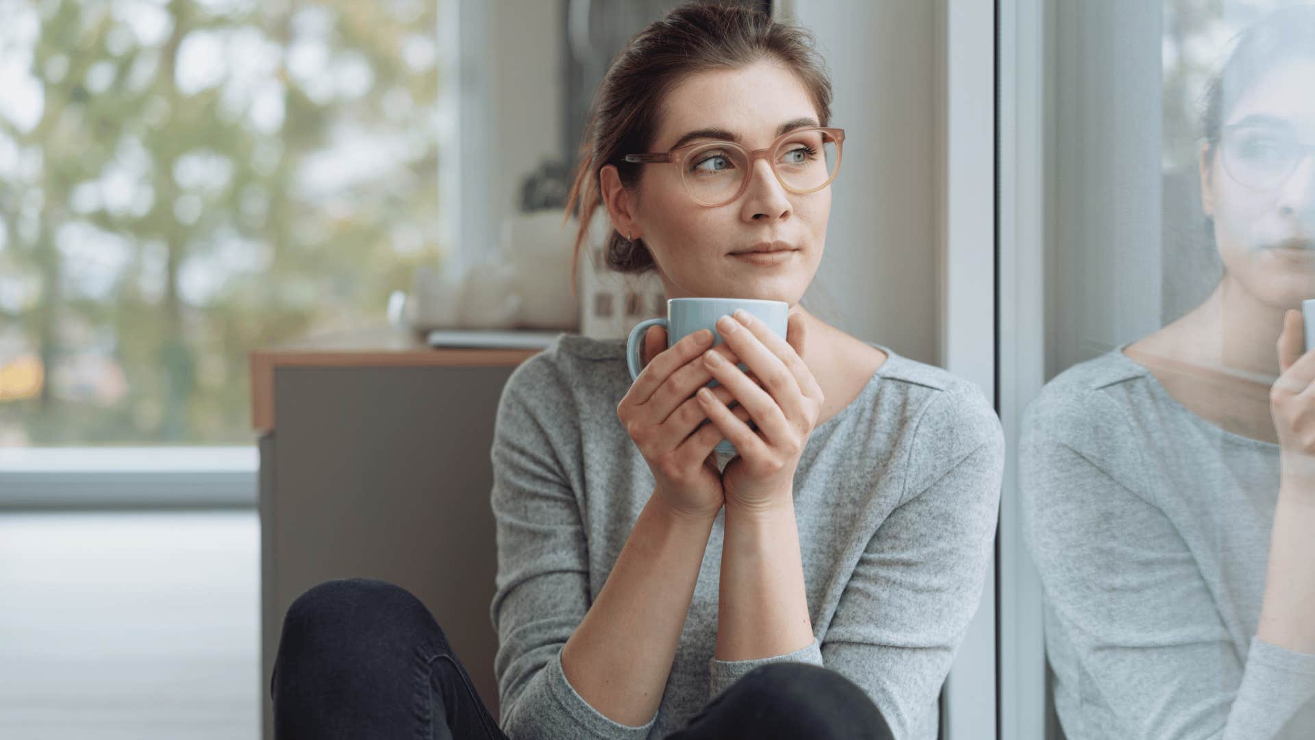 woman with a lonely childhood observing out her window