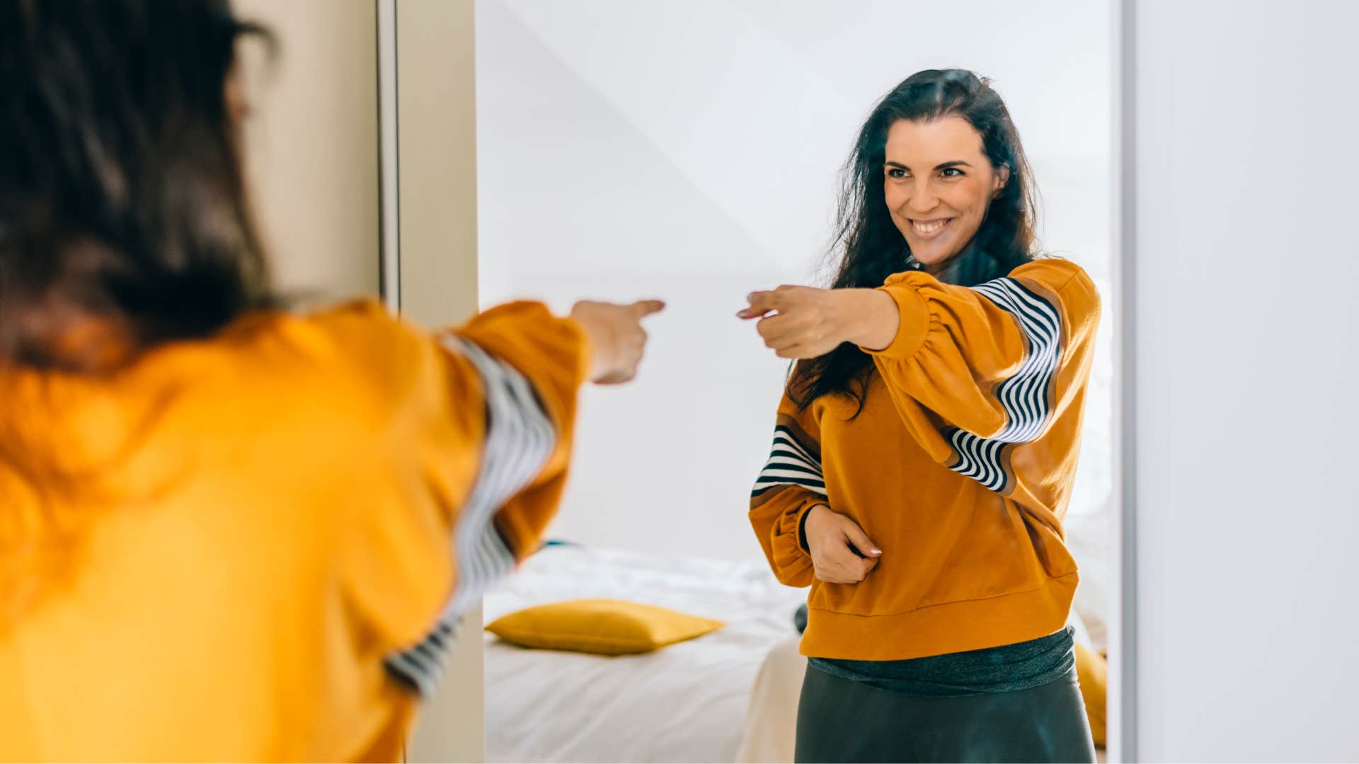 woman looking in mirror talking to herself