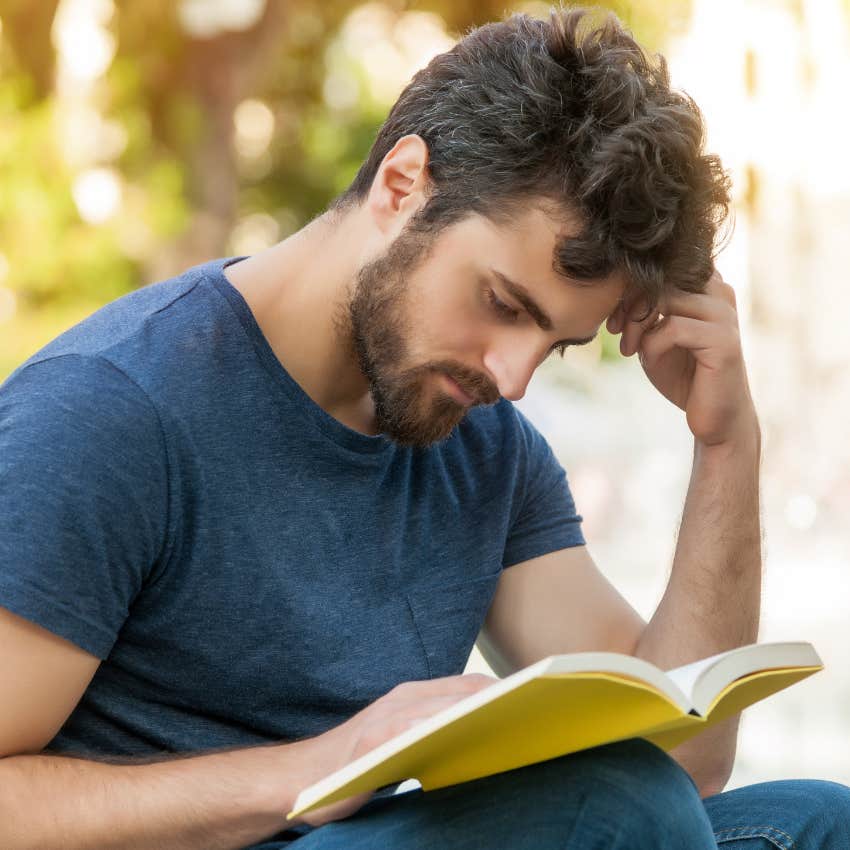 man who needs alone time to recharge reading outside