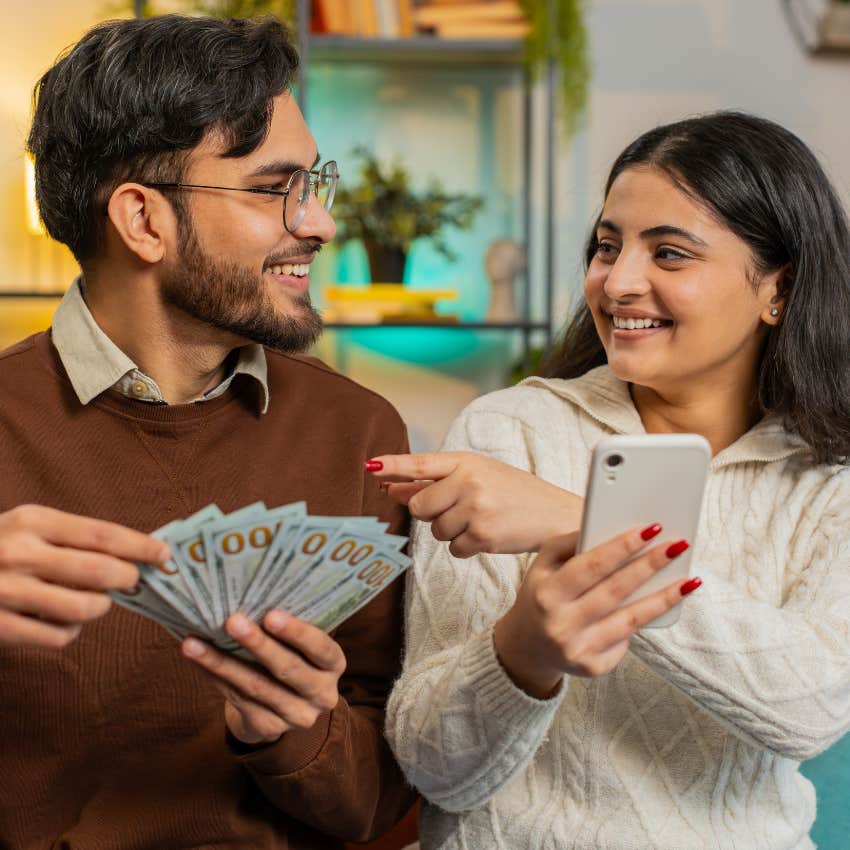 Couple budgeting with cash because they've got their lives together.
