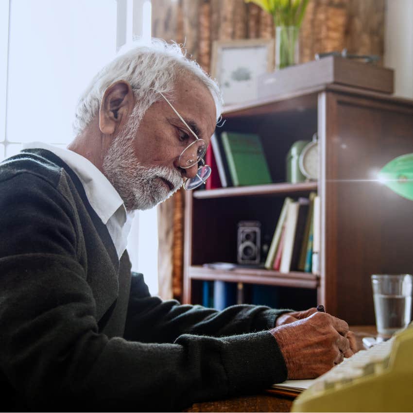 Man writing handwritten letters at home in an office.