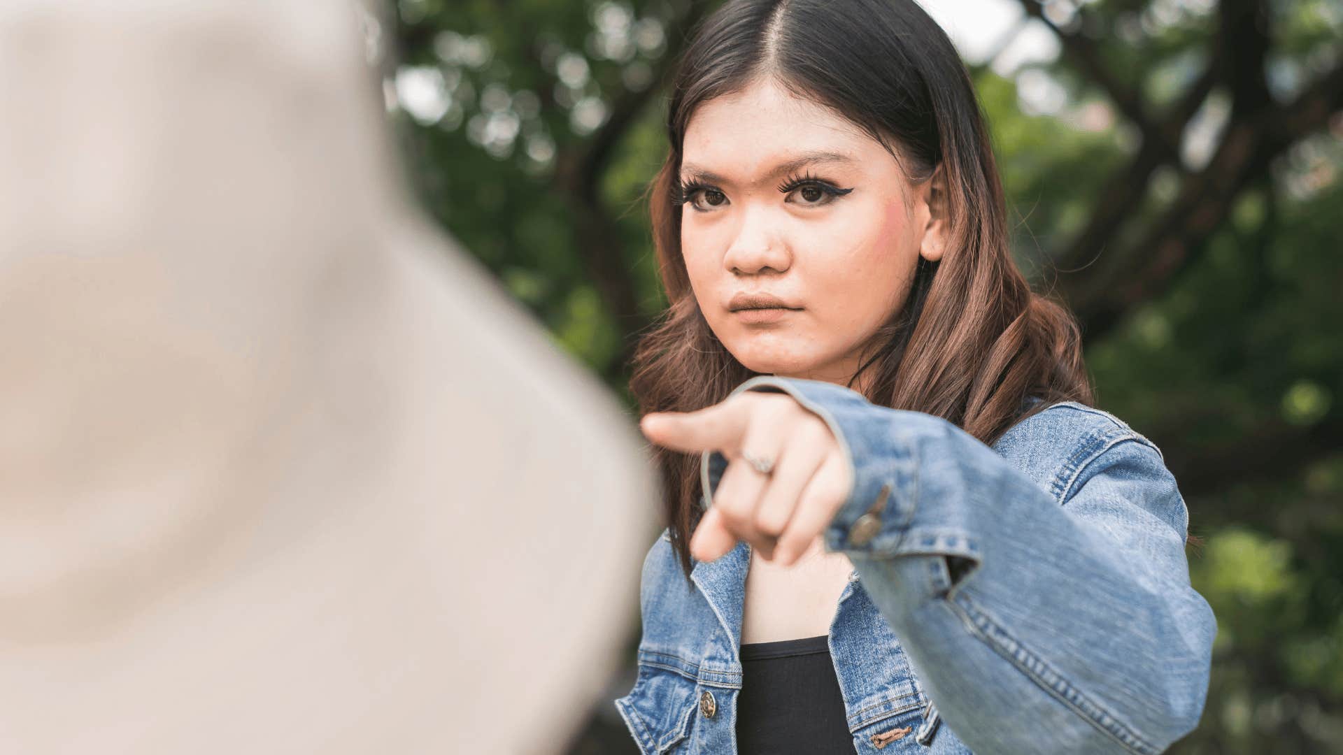 woman pointing her finger while incorrectly saying i could care less