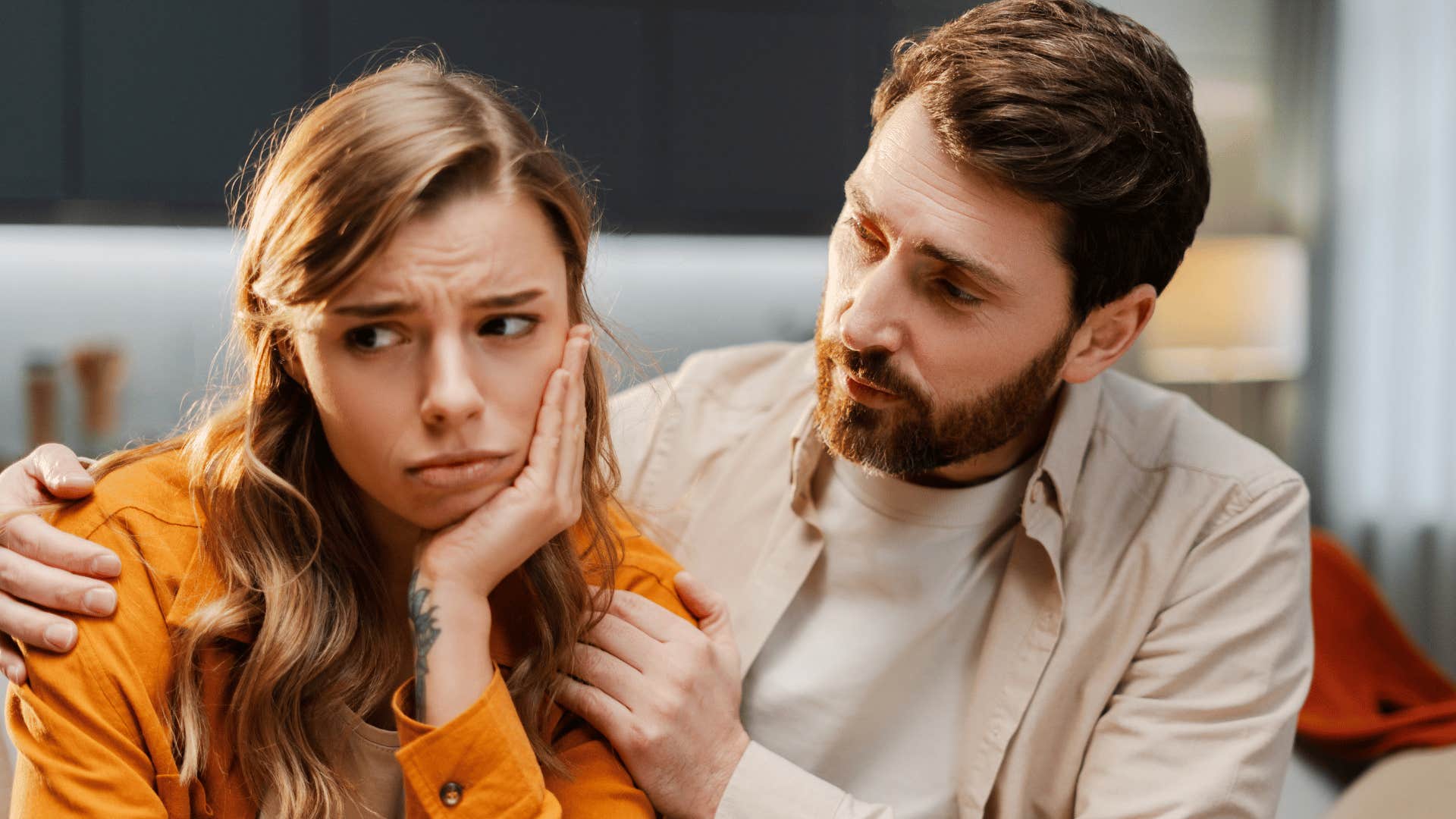 annoying man trying to comfort sad woman telling her everything happens for a reason
