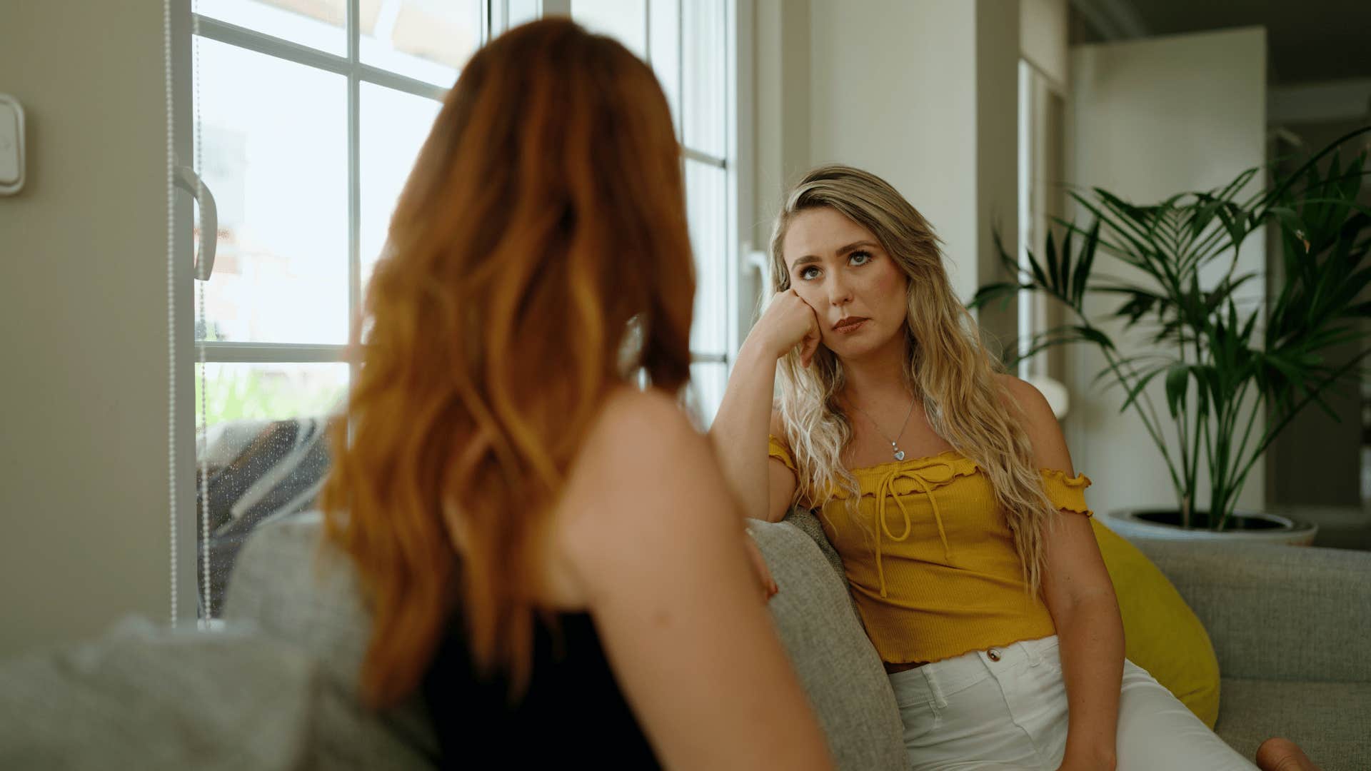 woman listening to annoying friend tell a long story while saying long story short