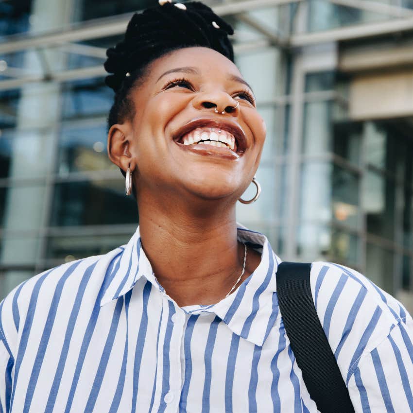 highly intelligent woman who has big personal goals smiling outside