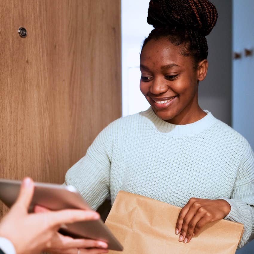 woman investing in herself accepting grocery delivery