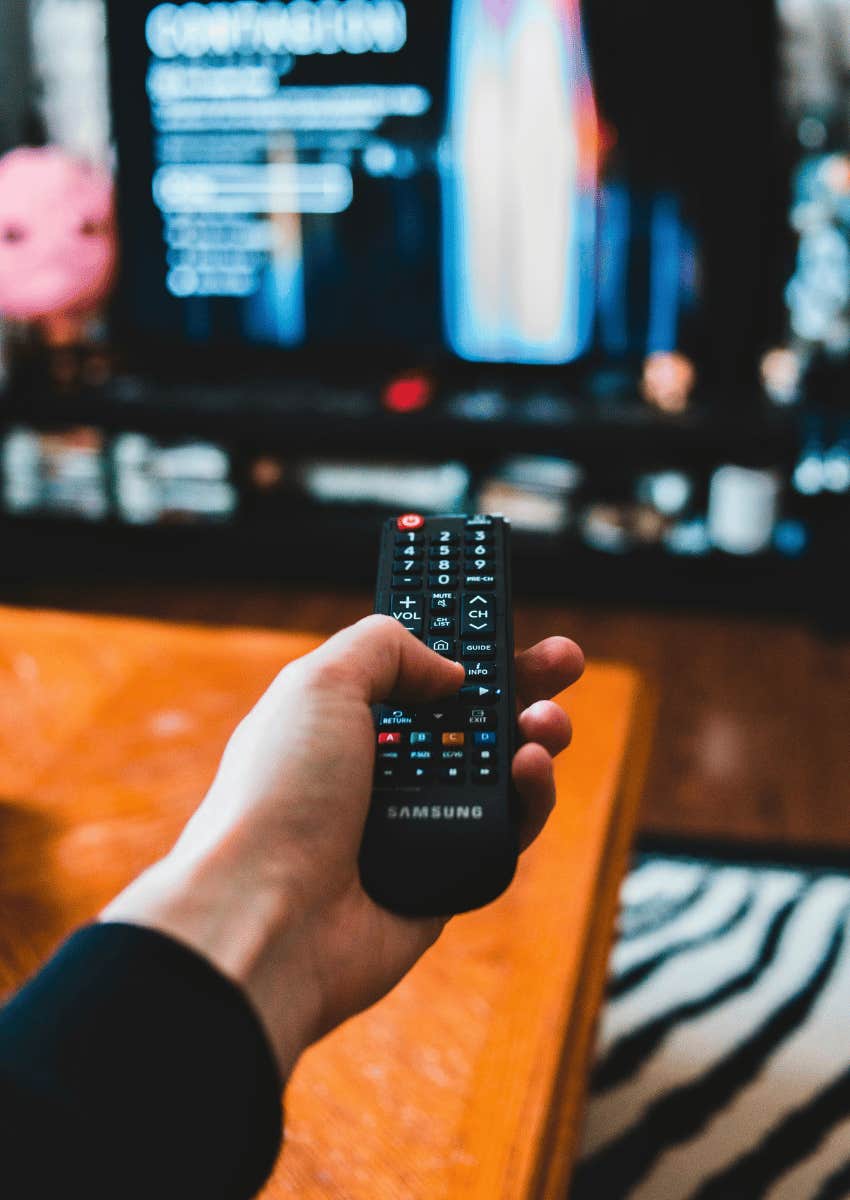 remote control pointed at tv playing a movie