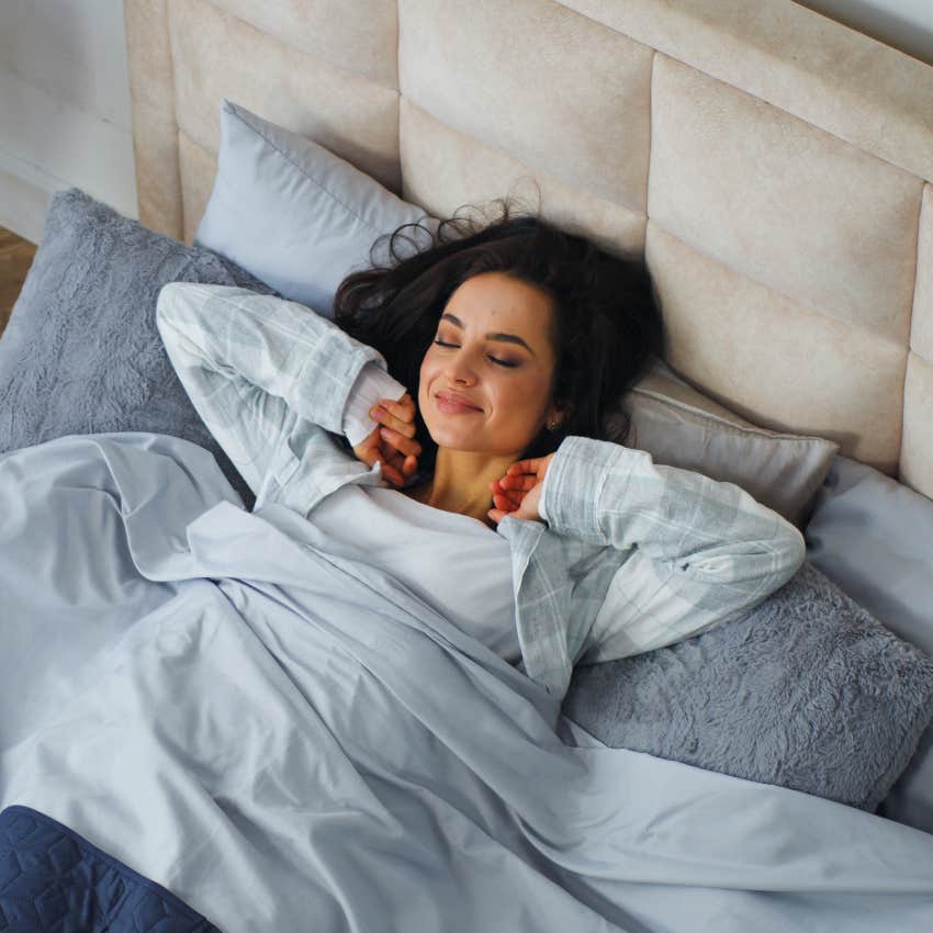 woman waking up in bed feeling refreshed