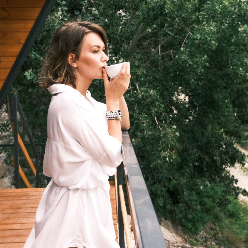 woman drinking tea outside enjoying alone time with herself