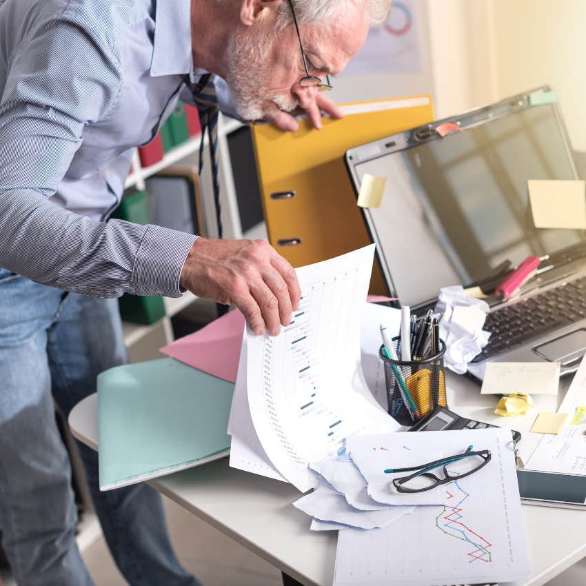 man thriving with his chaotic desk