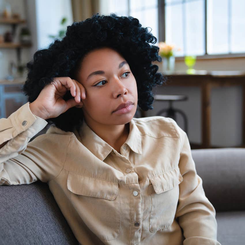lonely woman sitting on couch at home